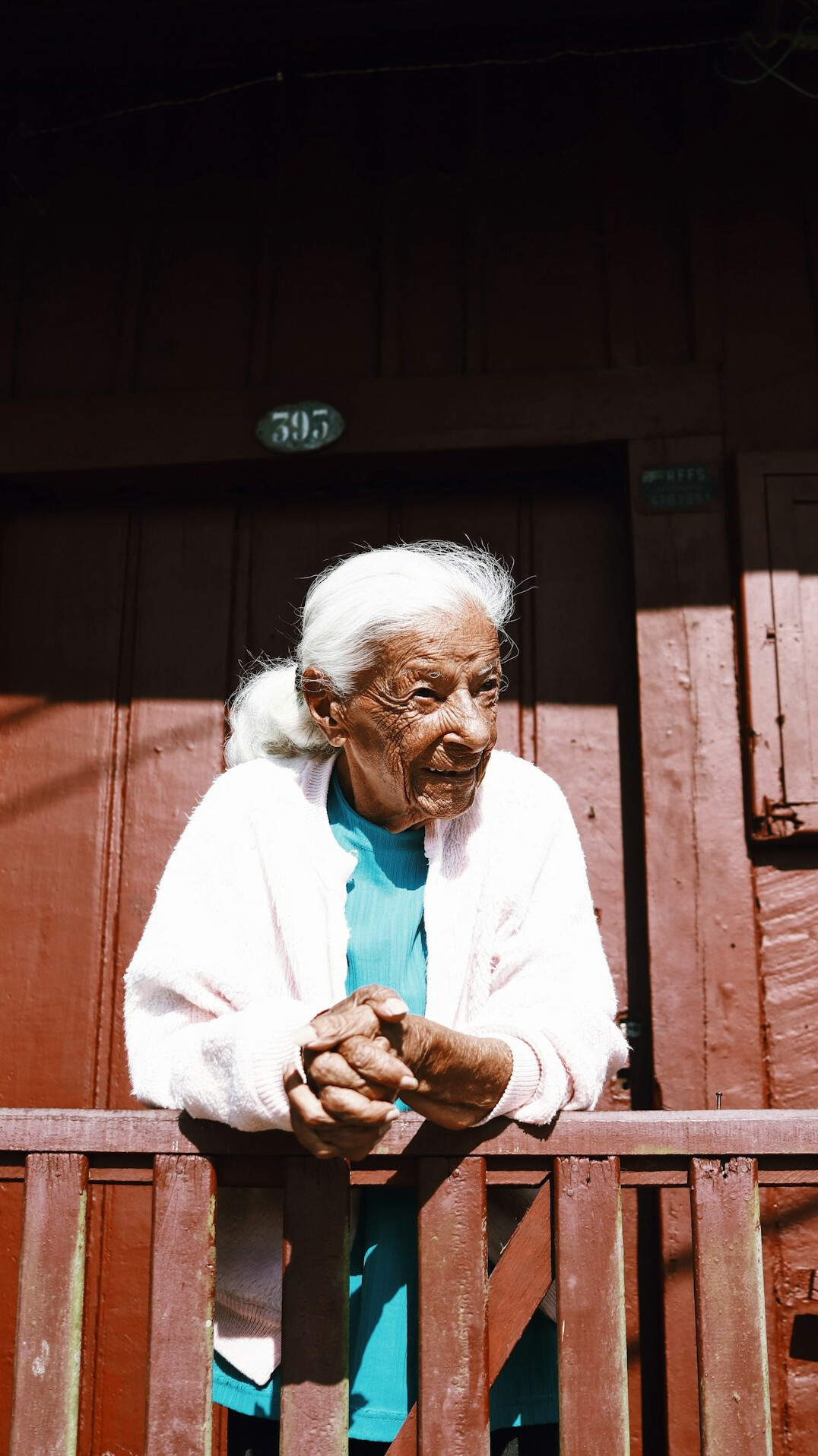 Portrait of a cheerful elderly woman with curly white hair
