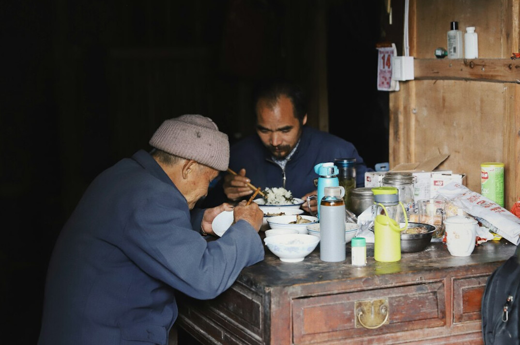 Older adults cooking together in a community kitchen
