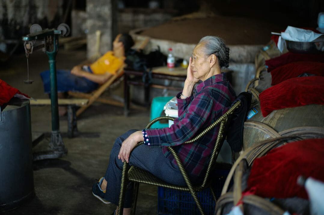 Older adults sitting together in a bright community room having coffee